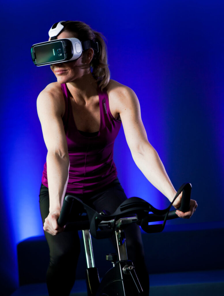 Woman on indoor bike with VR glasses