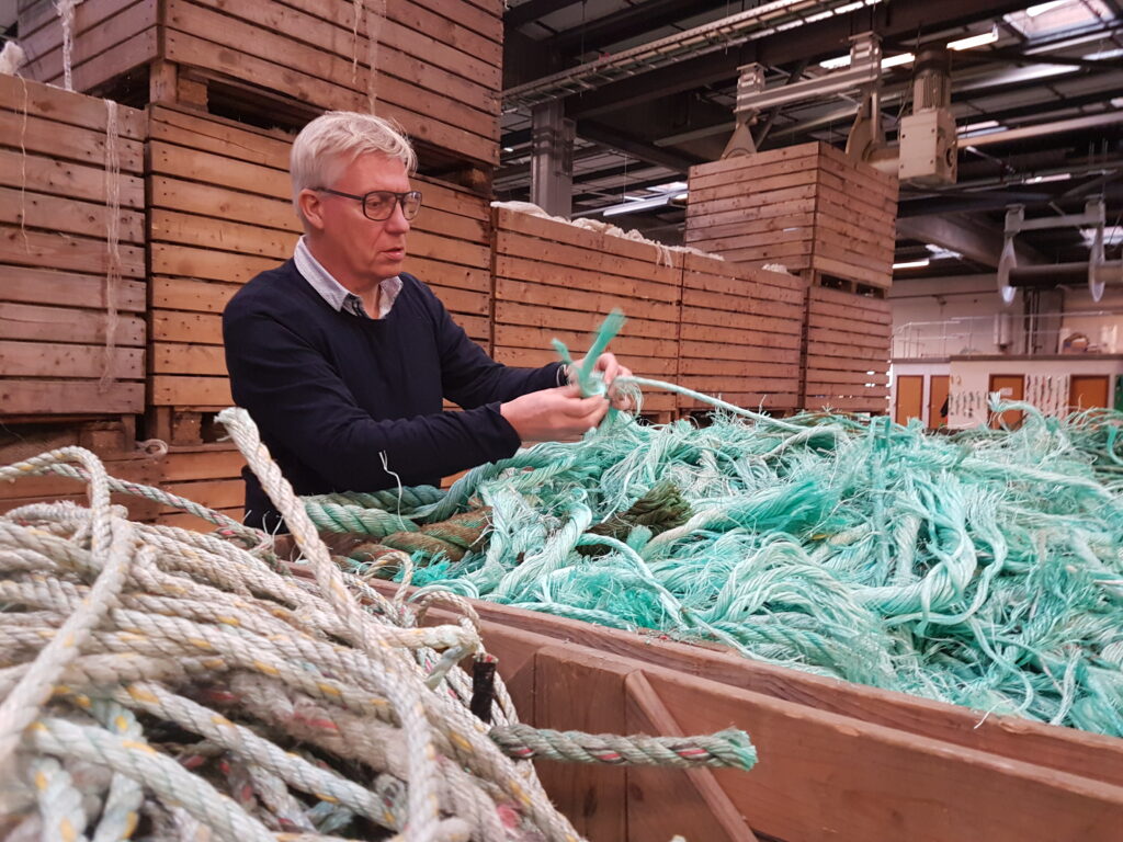 Uffe A. Olesen CEO of BODY BIKE indoor bikes checking fishing nets for recycling for the BODY BIKE OceanIX sustainable indoor bike.