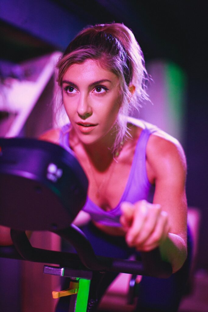 Close up of woman on indoor cycling bike spinning bike
